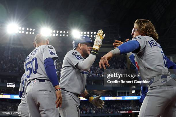 Toronto, Ontario, Saturday, November 1, 2025 - Los Angeles Dodgers second baseman Miguel Rojas is congratulated by Los Angeles Dodgers first baseman...