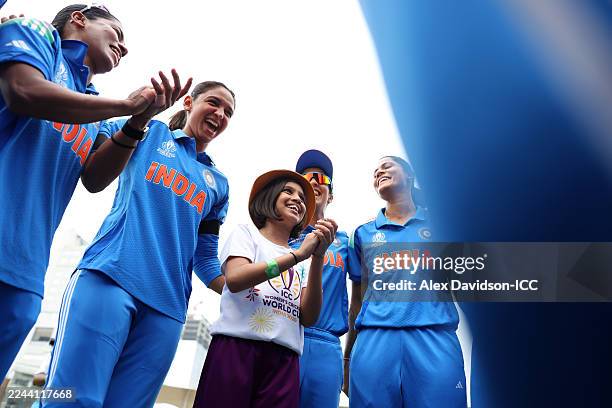 Harmanpreet Kaur of India speaks to the team in a huddle alongside a player mascot prior to the ICC Women's Cricket World Cup India 2025 Semi-Final...