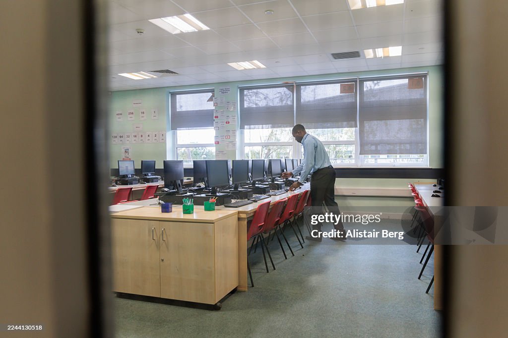 High school teacher getting ready to teach a class in a modern computer lab