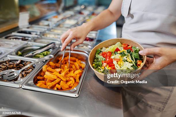 person choosing fresh ingredients at self-service salad bar - cantina imagens e fotografias de stock