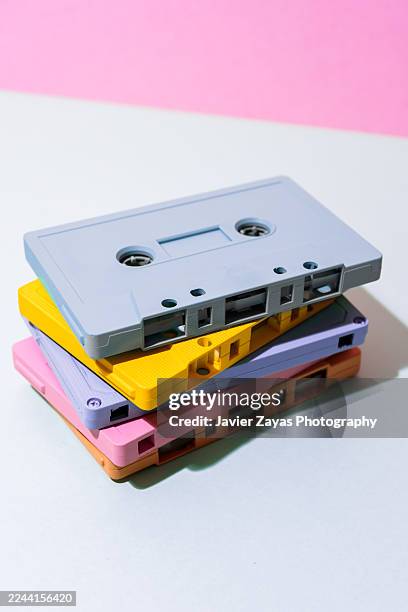 stack of colorful pastel cassette tapes creating a retro music concept - música pop fotografías e imágenes de stock