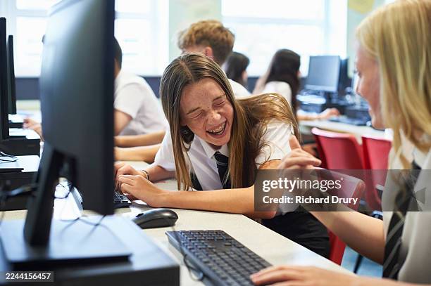 laughing schoolgirl in a high school computer lab - educational subject stock pictures, royalty-free photos & images