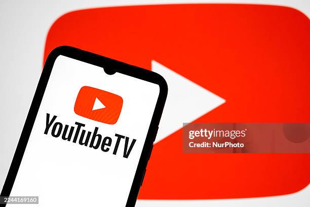 The YouTube TV logo appears on a smartphone screen, and the YouTube logo displays as the background on a laptop screen in this photo illustration in...