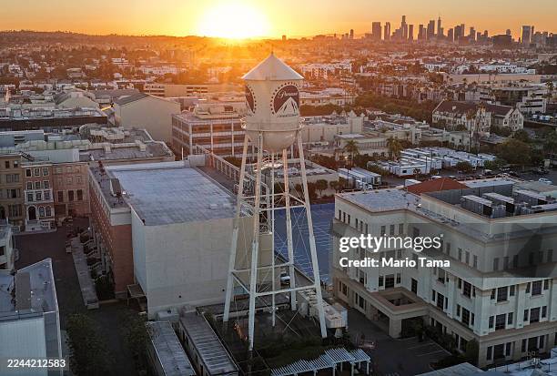 An aerial view of the sun rising beyond the water tower at Paramount Studios on October 30, 2025 in Los Angeles, California. Paramount, now renamed...