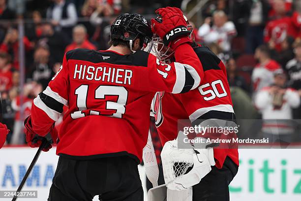 Nico Hischier of the New Jersey Devils celebrates with Nico Daws of the New Jersey Devils after defeating the Minnesota Wild at Prudential Center on...