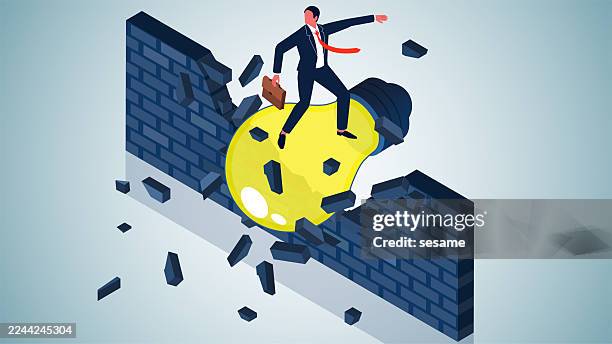 a breakthrough thought or idea that breaks the bounds of convention. isometric view businessman standing on a light bulb breaks through a blocking brick wall - hitting wall stock illustrations