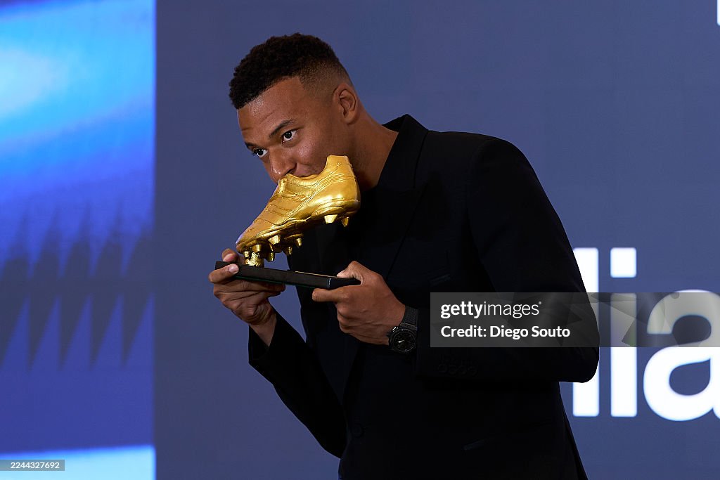 Kylian Mbappe Of Real Madrid Kisses The European Golden Shoe Award As kylian-mbappe-of-real-madrid-kisses-the-european-golden-shoe-award-as