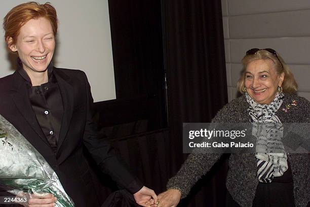 Freddie Hancock, Vice Chairman of BAFTA, presents flowers to Actress Tilda Swinton after a Q&A following the BAFTA screening of her film "Deep End"...