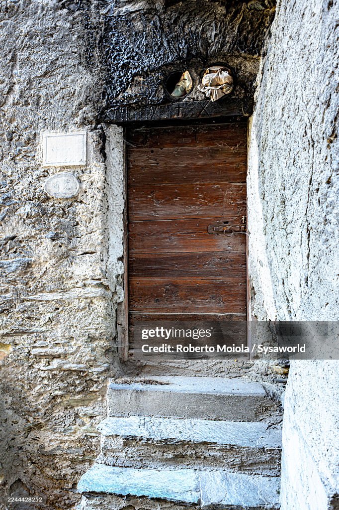 Wooden doorway and stone steps of a barn