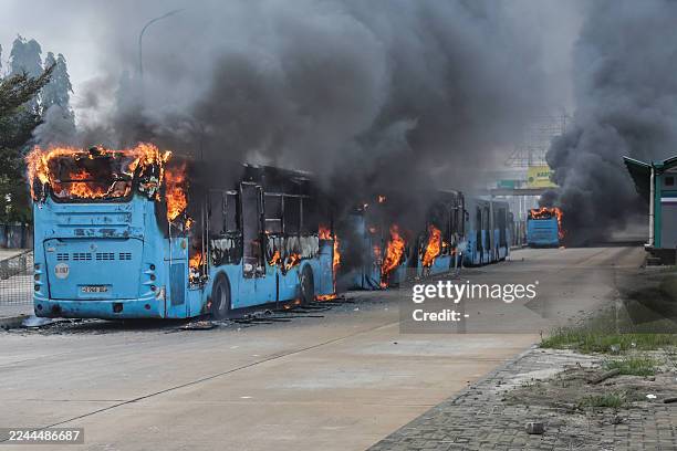 Public buses are set ablaze as clashes erupt in Dar es Salaam on October 29 during Tanzania's presidential elections. Hundreds protested on Wednesday...