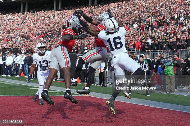 Defensive back Caleb Downs of the Ohio State Buckeyes intercept a pass intended for tight end Khalil Dinkins of the Penn State Nittany Lions Lions...