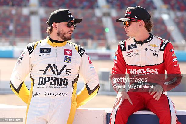 Taylor Gray, driver of the Operation 300 Toyota, and Jesse Love, driver of the Whelen Chevrolet, talk on the grid during qualifying for the NASCAR...