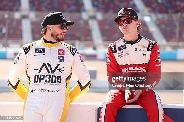 Taylor Gray, driver of the Operation 300 Toyota, and Jesse Love, driver of the Whelen Chevrolet, talk on the grid during qualifying for the NASCAR...