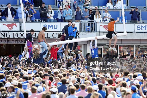Fans take down the goal posts after the Southern Methodist Mustangs defeat the Miami Hurricanes in overtime at Gerald J. Ford Stadium on November 01,...