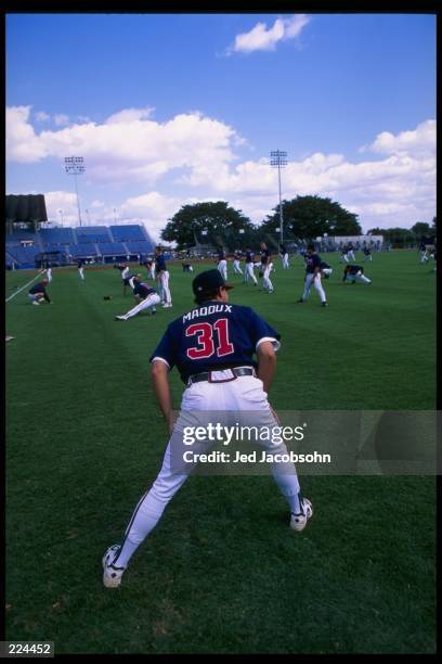 Pitcher Greg Maddux of the Atlanta Braves looks on during a spring training game against the Los Angeles Dodgers at Municipal Stadium in West Palm...