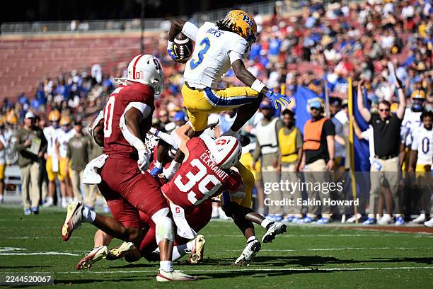 Cataurus Hicks of the Pittsburgh Panthers attempts to jump over Charlie Eckhardt of the Stanford Cardinal in the second quarter at Stanford Stadium...