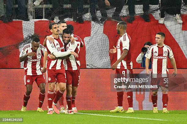 Olympiakos' players celebrate after scoring their first goal during the UEFA Champions League first round day 4 football match between Olympiakos and...