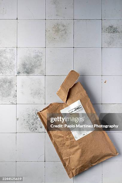 opened padded envelope on tile floor - padded envelope stock pictures, royalty-free photos & images