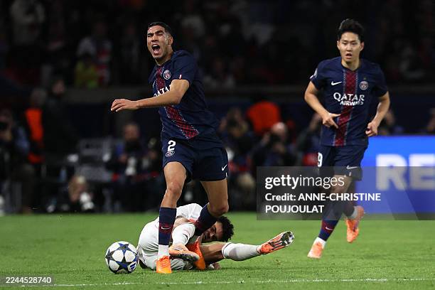 Paris Saint-Germain's Moroccan defender Achraf Hakimi reacts as he is tackled by Bayern Munich's Colombian forward Luis Diaz during the UEFA...