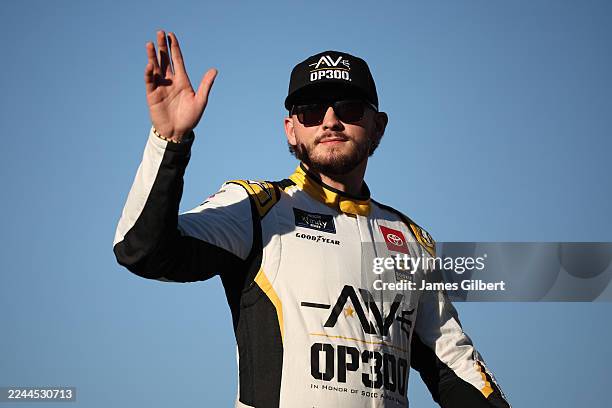 Taylor Gray, driver of the Operation 300 Toyota, waves to fans as he walks onstage during driver intros prior to the NASCAR Xfinity Series...