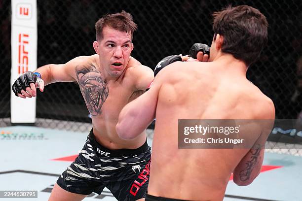 Cody Durden punches Allan Nascimento of Brazil in a 130-pound catchweight fight during the UFC Fight Night event at UFC APEX on November 01, 2025 in...
