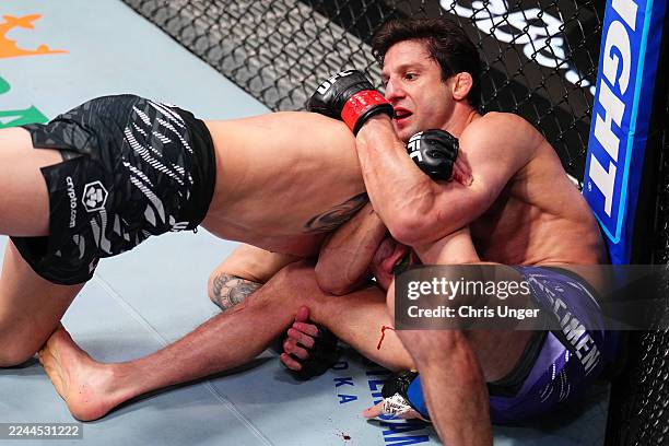 Allan Nascimento of Brazil secures a submission against Cody Durden in a 130-pound catchweight fight during the UFC Fight Night event at UFC APEX on...