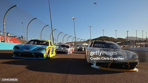 Taylor Gray, driver of the Operation 300 Toyota, and Brandon Jones, driver of the Menards/Magicwood Toyota, lead the field on a pace lap prior to the...