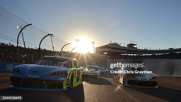 Brandon Jones, driver of the Menards/Magicwood Toyota, and Taylor Gray, driver of the Operation 300 Toyota, lead the field on a pace lap prior to the...