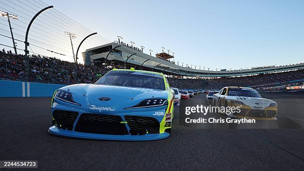 Brandon Jones, driver of the Menards/Magicwood Toyota, and Taylor Gray, driver of the Operation 300 Toyota, lead the field on a pace lap prior to the...
