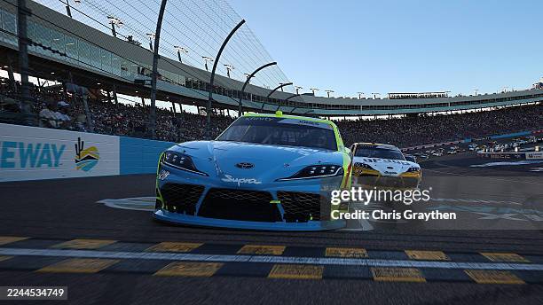 Brandon Jones, driver of the Menards/Magicwood Toyota, and Taylor Gray, driver of the Operation 300 Toyota, lead the field on a pace lap prior to the...