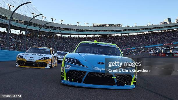 Brandon Jones, driver of the Menards/Magicwood Toyota, and Taylor Gray, driver of the Operation 300 Toyota, lead the field on a pace lap prior to the...