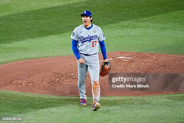 Shohei Ohtani of the Los Angeles Dodgers reacts after striking out Andrés Giménez of the Toronto Blue Jays to end the second inning in game seven of...
