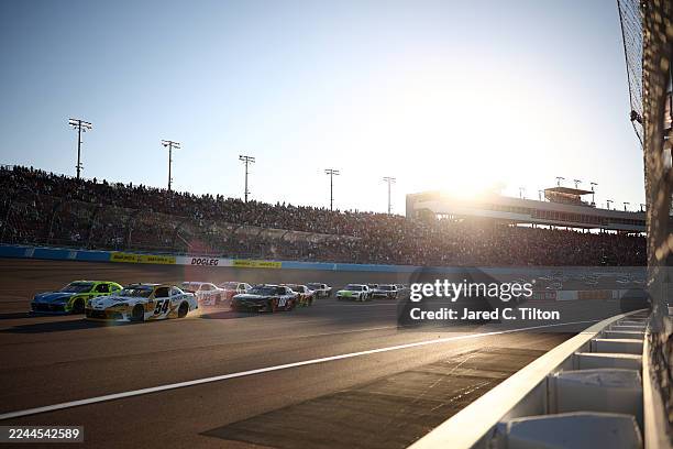 Taylor Gray, driver of the Operation 300 Toyota, and Brandon Jones, driver of the Menards/Magicwood Toyota, lead the field during the NASCAR Xfinity...