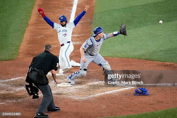 Will Smith of the Los Angeles Dodgers forces Isiah Kiner-Falefa of the Toronto Blue Jays out at home plate for the second out during the ninth inning...