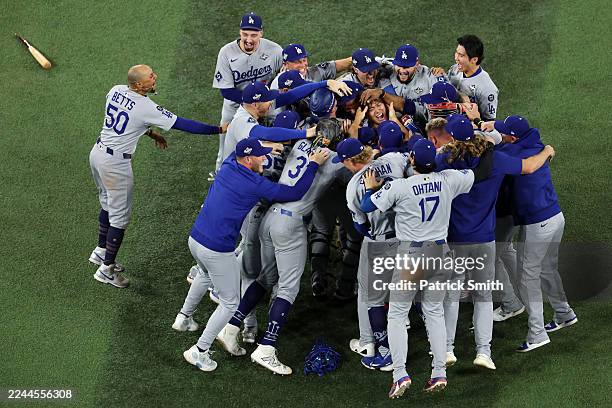 Mookie Betts of the Los Angeles Dodgers celebrates with teammates after defeating the Toronto Blue Jays 5-4 in game seven of the 2025 World Series at...