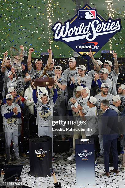 Yoshinobu Yamamoto of the Los Angeles Dodgers raises the Willie Mays World Series Most Valuable Player Award after defeating the Toronto Blue Jays...