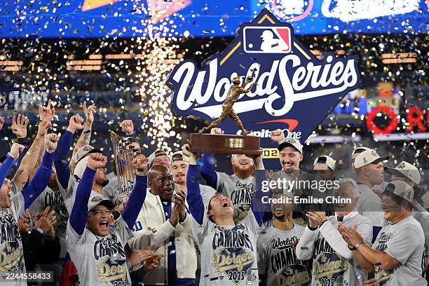 Yoshinobu Yamamoto of the Los Angeles Dodgers raises the Willie Mays World Series Most Valuable Player Award after defeating the Toronto Blue Jays...