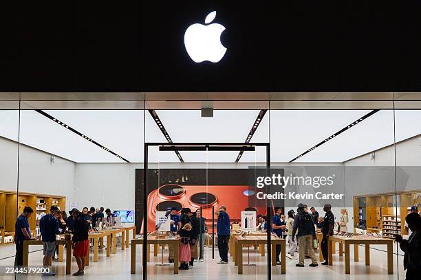 Customers stand in an Apple store on November 3, 2025 in San Diego, California.