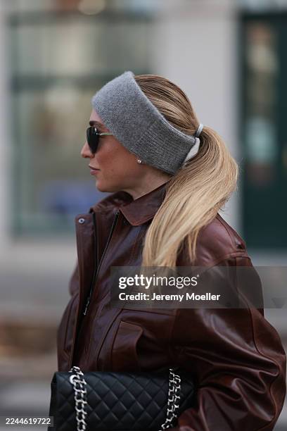 Sonia Lyson seen wearing wide-leg grey pinstripe wool pants by The Frankie Shop paired with a soft, fluffy light-grey knit sweater from & Other...