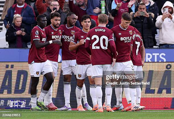 Lucas Paqueta of West Ham United celebrates scoring his team's first goal with teammates Jarrod Bowen and Freddie Potts during the Premier League...