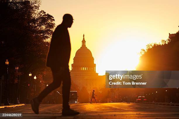 Pedestrians walks along Pennsylvania Avenue near the U.S. Capitol during sunrise on November 5, 2025 in Washington, DC. The record for longest...