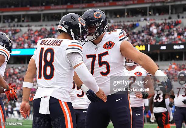 Caleb Williams of the Chicago Bears celebrates a touchdown with Ozzy Trapilo during the first quarter against the Cincinnati Bengals in the game at...