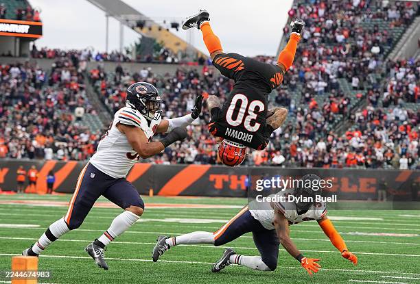 Chase Brown of the Cincinnati Bengals leaps over Kevin Byard III of the Chicago Bears during the fourth quarter in the game at Paycor Stadium on...