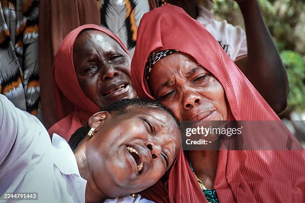 Mourners react as they gather around the coffin to pay their final respects to Michael Christian, Chairman of Youth for Nyamagana District of...