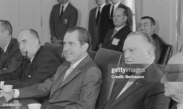 Director, J. Edgar Hoover, President Richard Nixon, and Attorney General John Mitchell are seen here at a meeting regarding violence against police...