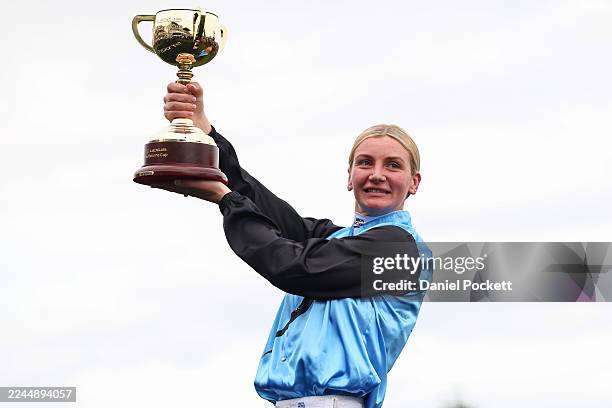 Jamie Melham raises the 2025 Lexus Melbourne Cup after riding Half Yours to win race seven the Lexus Melbourne Cup during Melbourne Cup Day at...
