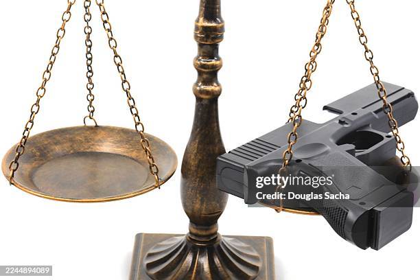 second amendment concepts - firearm on a scale - gun control stock pictures, royalty-free photos & images