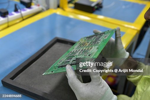 Quality Control Technician Inspecting Surface-Mounted Components on PCB After SMT Process Quality Control Technician Inspecting Surface-Mounted Components on PCB After SMT Process