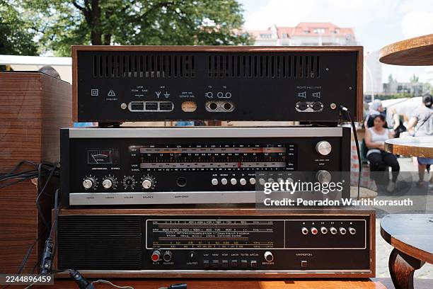 close-up of three stacked vintage german audio receiver components at an outdoor flea market. - stereo stock pictures, royalty-free photos & images