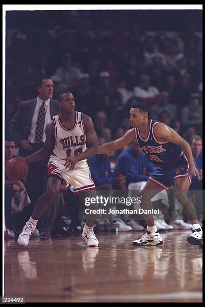 Guard B. J. Armstrong of the Chicago Bulls moves the ball against guard John Starks of the New York Knicks during a game at the United Center in...